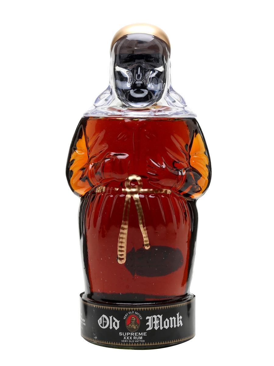Bottle of Old Monk rum with a monk figure design on a white background