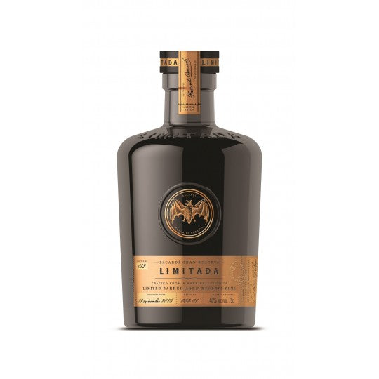 Paramount Bacardi Reserva Limitada dark rum bottle, 750ml with a dark label and gold accents, on a wooden surface.