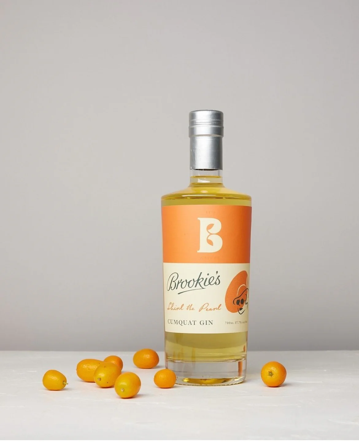 Paramount Brookie's Shirl the Pearl Cumquat Gin 700mL bottle with colorful label and clear glass showcasing the gin inside