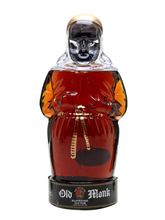 Bottle of Old Monk rum with a monk figure design on a white background