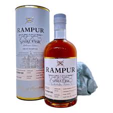 Rampur Melbourne 700mL single malt whiskey by LiquorDay, showcasing a rich amber color with a textured label and cap.