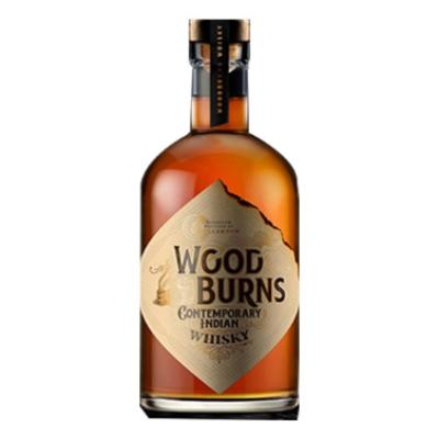 Bottle of LiquorDay Woodburns Whisky 700ml with amber-colored liquid and label, displayed upright on a wooden surface.
