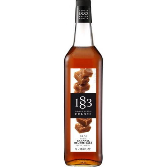 Paramount 1883 Salted Caramel Flavored Syrup in a 1L bottle, creamy caramel color, ideal for coffee and desserts.