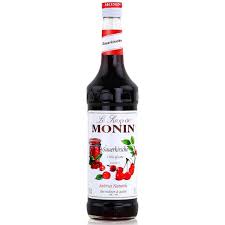 Paramount MONIN Cherry flavored syrup in a 700 mL bottle, showing the dark red cherry syrup inside.