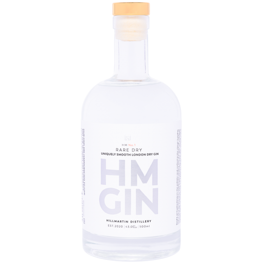 Paramount HM Gin Rare Dry Gin 500ml bottle with clear glass and label featuring botanical illustrations, on a wooden surface.