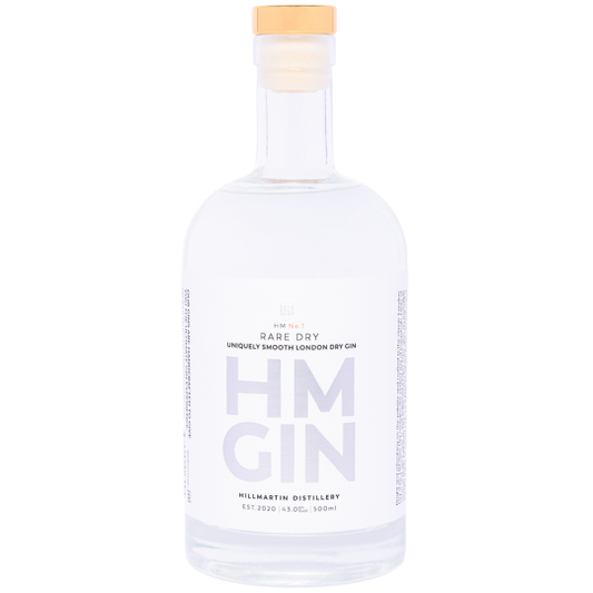 Paramount HM Gin Rare Dry Gin 500ml bottle with clear glass and label featuring botanical illustrations, on a wooden surface.